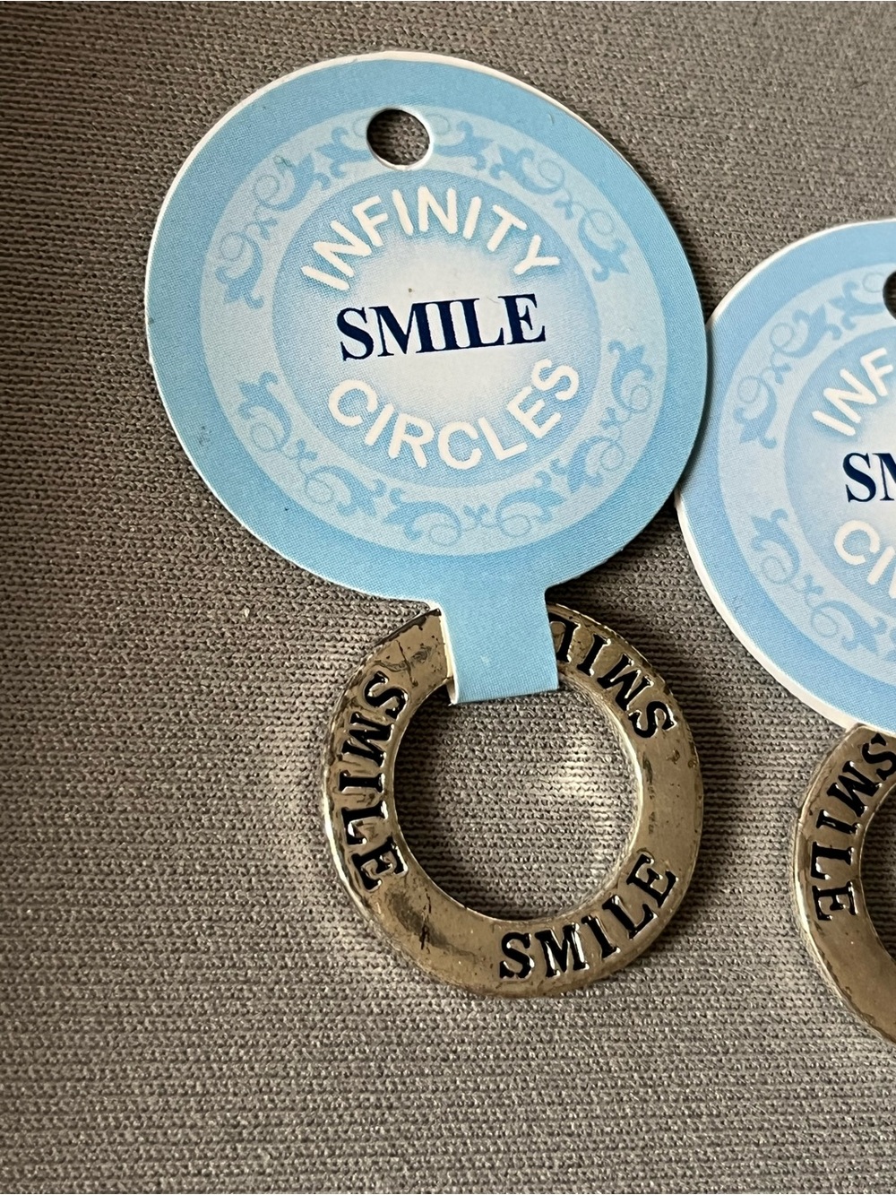 NWT six infinity circle imprinted with smile.  Layered in sterling silver.